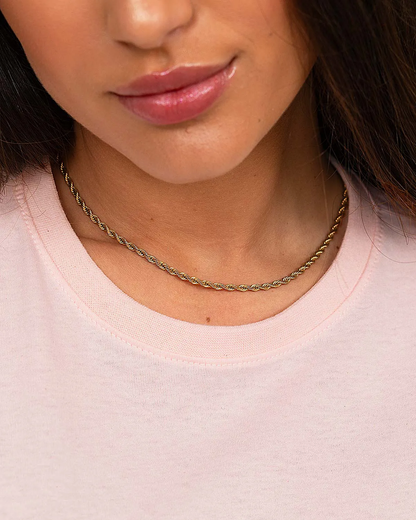 “Close-up of ribbed neckline on women’s pink 100% cotton T-shirt.”