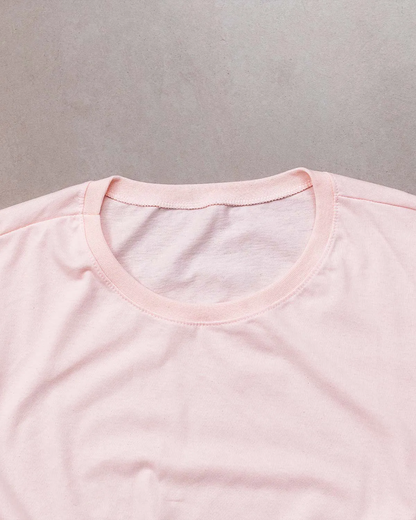 “Fabric texture detail of women’s pink 100% cotton relaxed fit T-shirt.”