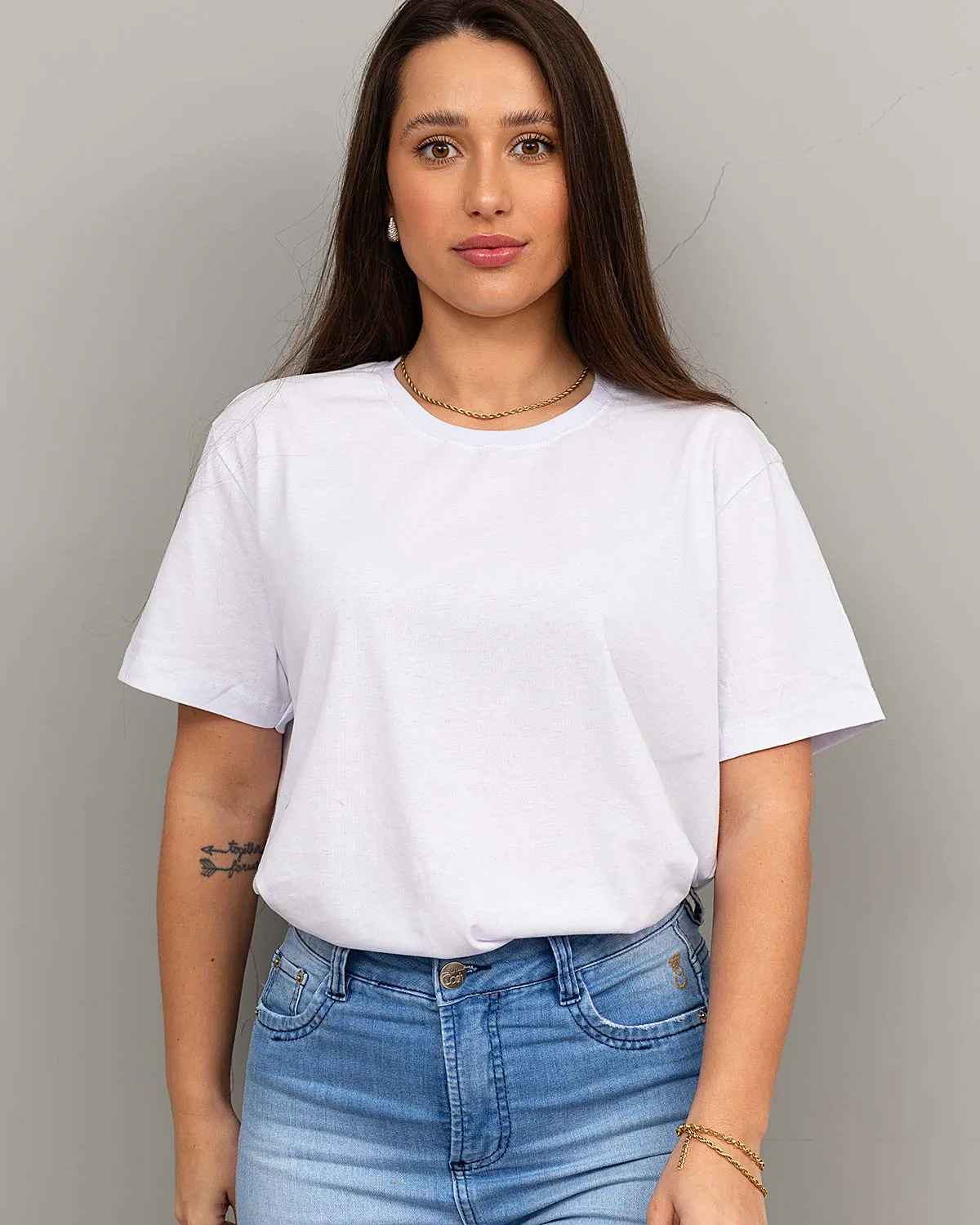 “Model wearing white relaxed fit women’s 100% cotton T-shirt – front view.”